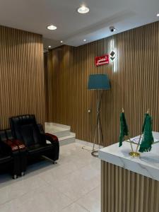 a lobby with a couch and a chair in a room at Bahget Eljouf Furnished Apartment in Aţ Ţuwayr