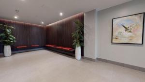 a waiting room with red benches and plants at Luxury Central Apartment in London