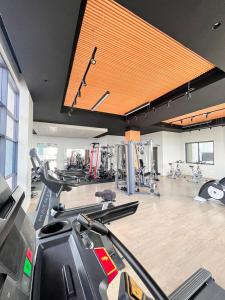 a gym with a lot of treadmills and machines at Melodious homes elite residency in Nairobi