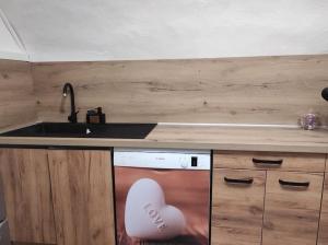 a kitchen with a sink and a dishwasher at Gite au nid d'Ange in Lincel +38 photos
