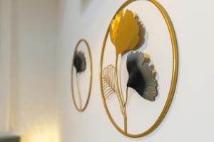 a mirror with a yellow flower on a wall at Bubbly Apartment in Bled