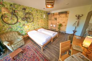 a bedroom with a bed and a bicycle on the wall at Maskuline Idylle - Monteurwohnungen inkl. Küchen/WIFI/TV/Parkplätze in Bielefeld
