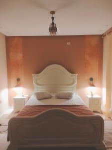 um quarto com uma cama grande e 2 mesas de cabeceira em Dar Ranim Tozeur em Tozeur