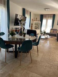a living room with a table and chairs at Villa avec piscine au soleil de la côte d’azur in Mouans-Sartoux