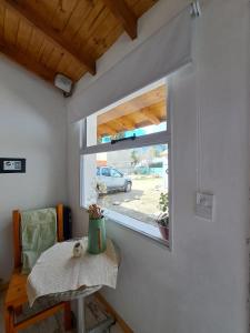 a small room with a table and a window at Apartamentos-Cabañas Encanto II in El Bolsón +19 photos