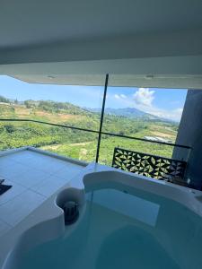 a bath tub in a room with a view at Luxurious With Private Jacuzzi 3-Bedroom Apartment in Pereira in San Joaquín