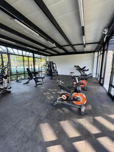 a gym with two bikes and exercise machines in it at Luxurious With Private Jacuzzi 3-Bedroom Apartment in Pereira in San Joaquín