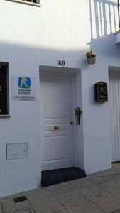 a white door with a sign on the side of a building at Casa Rural Montepinar in El Bosque