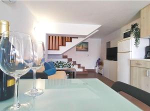 two wine glasses sitting on a table in a living room at Schöne Wohnung Sun Club in Playa del Aguila