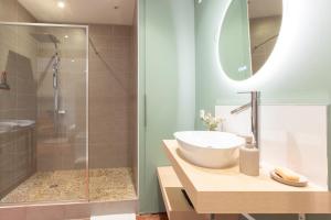 a bathroom with a sink and a shower at Escale de Giulia in Beaune