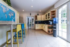 a kitchen with a table and yellow chairs at Villa Sweet Birds in Noisy-le-Grand