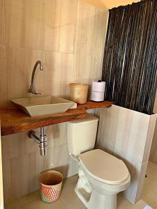 a bathroom with a sink and a toilet at La Triada in Ríohacha