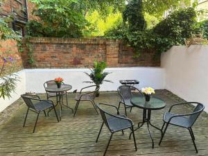 a group of tables and chairs on a patio at Comfortable Family Villa in London