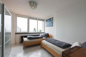 a room with two beds and a window at Munich Rooftop Retreat in Munich