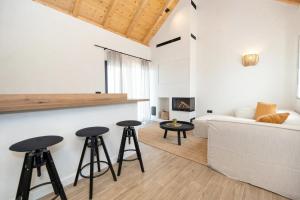 a living room with a couch and two stools at Rocca Verde in Murvica