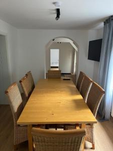 a dining room table with chairs and a large mirror at Apartments zum Wildgehege in Siegen
