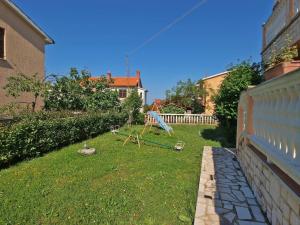 einen Hof mit einer Schaukel im Gras in der Unterkunft Studio für 5 Personen ca 50 qm in Fažana, Istrien Istrische Riviera - b60991 in Fažana