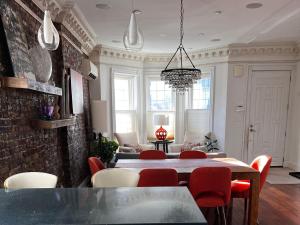 a dining room with a table and red chairs at GEM of a Free-Standing Family House in Great Neighborhood in Brooklyn