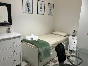 a small bedroom with a bed and a chair at A casa da Carlo in Palermo