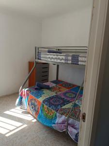 a bedroom with a bunk bed with a quilt on it at Casa Rural Natur Libre in Alicante