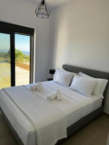 a bedroom with a large bed with towels on it at Villa Elaia in Sitia