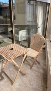 a wooden chair sitting on top of a balcony at Un studio de luxe Les Champs Elysées in Paris