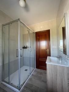 a bathroom with a shower and a sink at La Ventana de Picos in Onís