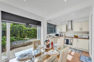 a kitchen and dining room with a table and chairs at Relaxed Home in Eltham
