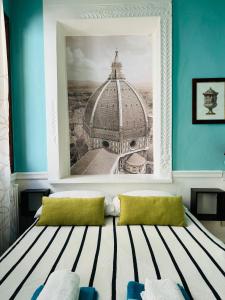 a room with a picture of a building on the wall at Santo Spirito Suite in Florence