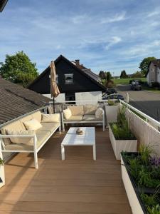 a patio with couches and a table and an umbrella at Spacy 3 Bedroom plus Sleeping couch Apartment Work&Travel close to Heidelberg in Dielheim