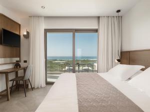 a hotel room with a bed and a view of the ocean at Villa Aora Falassarna Beach I New luxury villa with infinity pool in Falasarna +99 photos