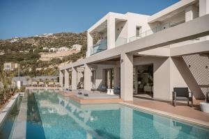 a house with a swimming pool in front of it at Villa Aora Falassarna Beach I New luxury villa with infinity pool in Falasarna