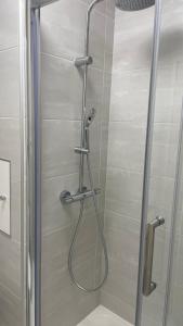 a shower with a glass door in a bathroom at Un studio de luxe Les Champs Elysées in Paris