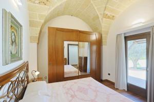 Postel nebo postele na pokoji v ubytování villa dei cento Pini