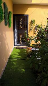 a front door of a house with a green lawn at Areito Vintage in Enriquillo