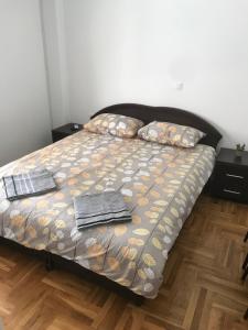 a bedroom with a bed with two towels on it at Guest House Sani in Skopje