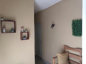 a hallway with a door and a mirror and a chair at Areito Vintage in Enriquillo