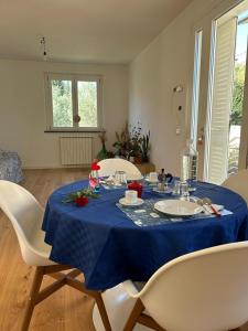 a dining room table with a blue table cloth on it at Casa Elogi in Buti