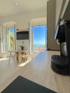 a large room with a view of the ocean from a room at MENTON # MONACO - F1 GP - 4 PERSONS - SEA VIEW - NEW - PARKING - CLIM - PREMIUM - BEACH and SUN in Menton