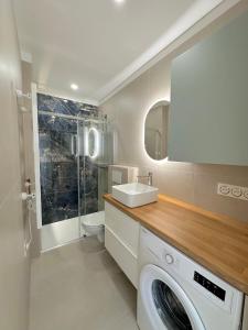 a bathroom with a washing machine and a sink at MENTON # MONACO - F1 GP - 4 PERSONS - SEA VIEW - NEW - PARKING - CLIM - PREMIUM - BEACH and SUN in Menton
