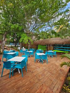 a bunch of tables and chairs on a wooden deck at Estancia del Agua Luxury View in Xul-Ha
