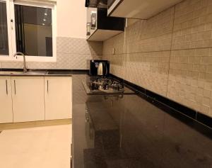 a kitchen with a sink and a counter top at Central City 2BHK by StayMehman in Rawalpindi