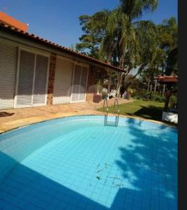 a swimming pool in front of a house at Hotel & Casa de Charme Estadio Morumbi 24 Hs in Sao Paulo
