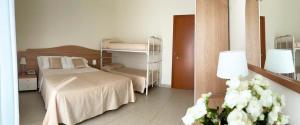 Postel nebo postele na pokoji v ubytování Hotel Majestic