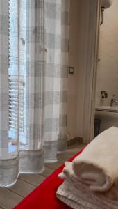 a bedroom with a bed and a window with a sink at Il Palazzetto in Gaeta