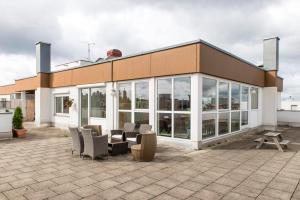 a building with a lot of windows and chairs at Munich Rooftop Retreat in Munich