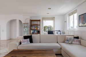 a living room with a couch and a table at Munich Rooftop Retreat in Munich