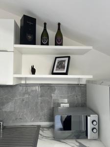 two bottles of wine sitting on shelves in a room at La dimora in Borgo San Dalmazzo +12 photos