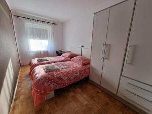 een kleine slaapkamer met een bed en een dressoir bij Pri Stari murvi in Vogrsko
