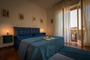 um quarto com uma cama com um cobertor azul e uma janela em Ferienwohnung für 6 Personen ca 105 qm in Lucca, Toskana Provinz Lucca em Lucca